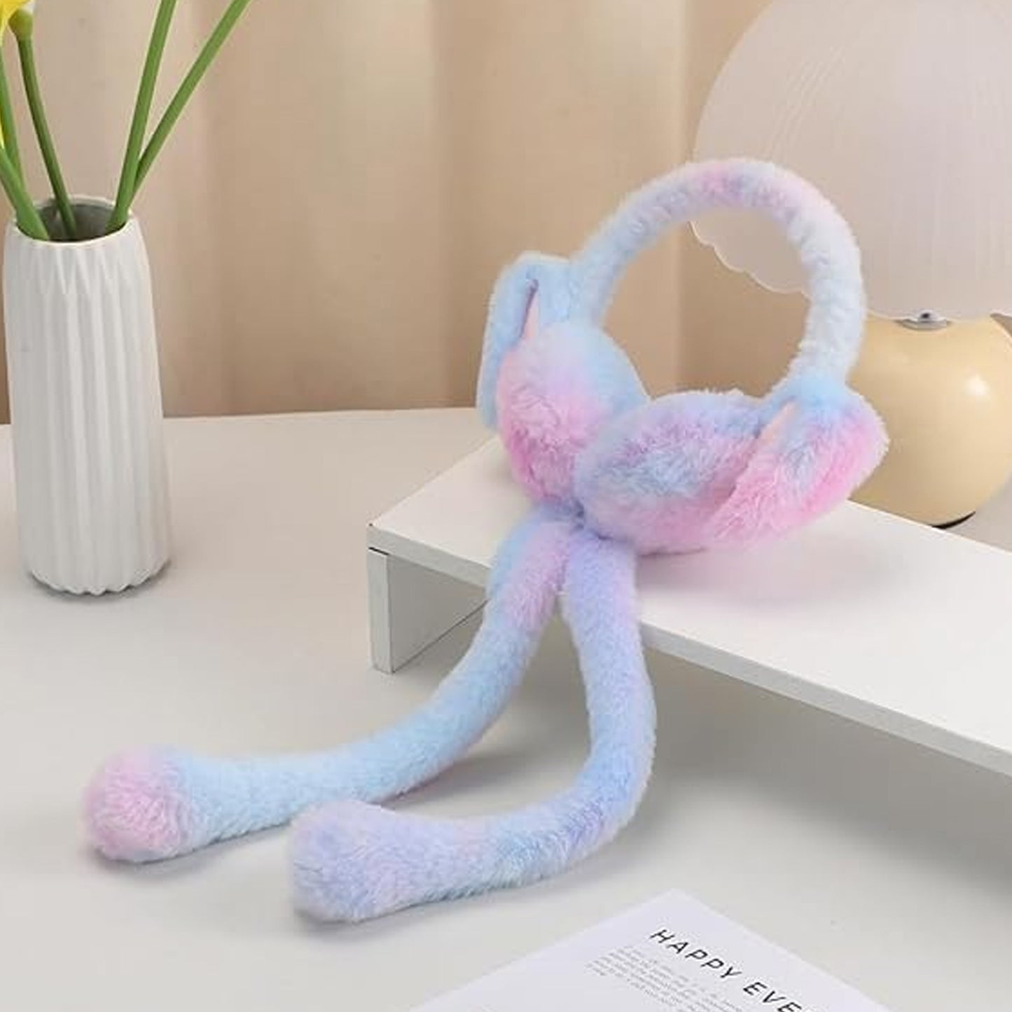 Soft plush winter earmuffs for kids by Wukusy, showing pink and gray cozy earmuffs with fluffy material and headband design.