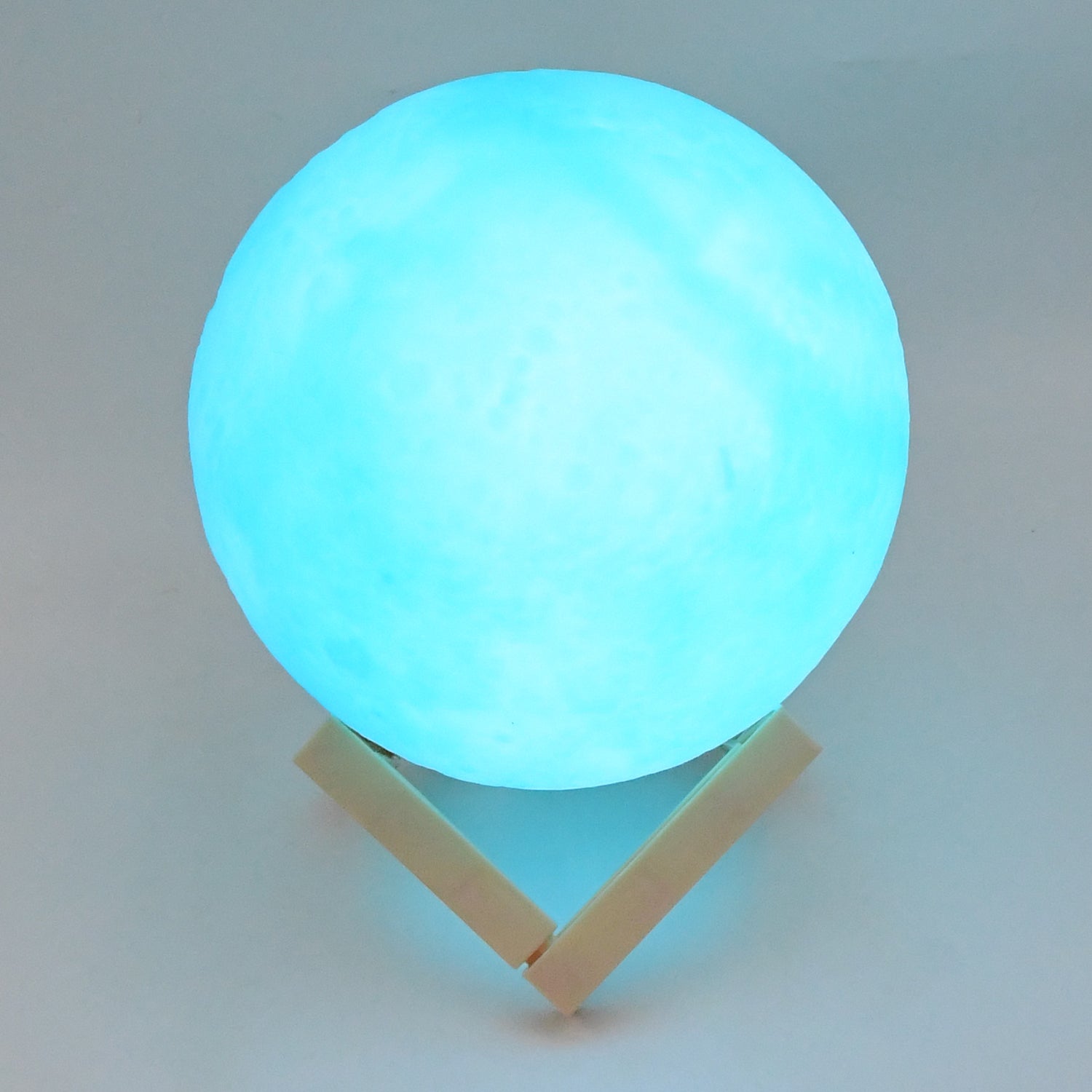Blue moon night lamp by Wukusy with plastic stand, 15x12 cm, perfect for home decor and ambient lighting.