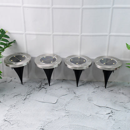 Set of four Wukusy solar-powered LED garden lights illuminating outdoor pathway and garden area.