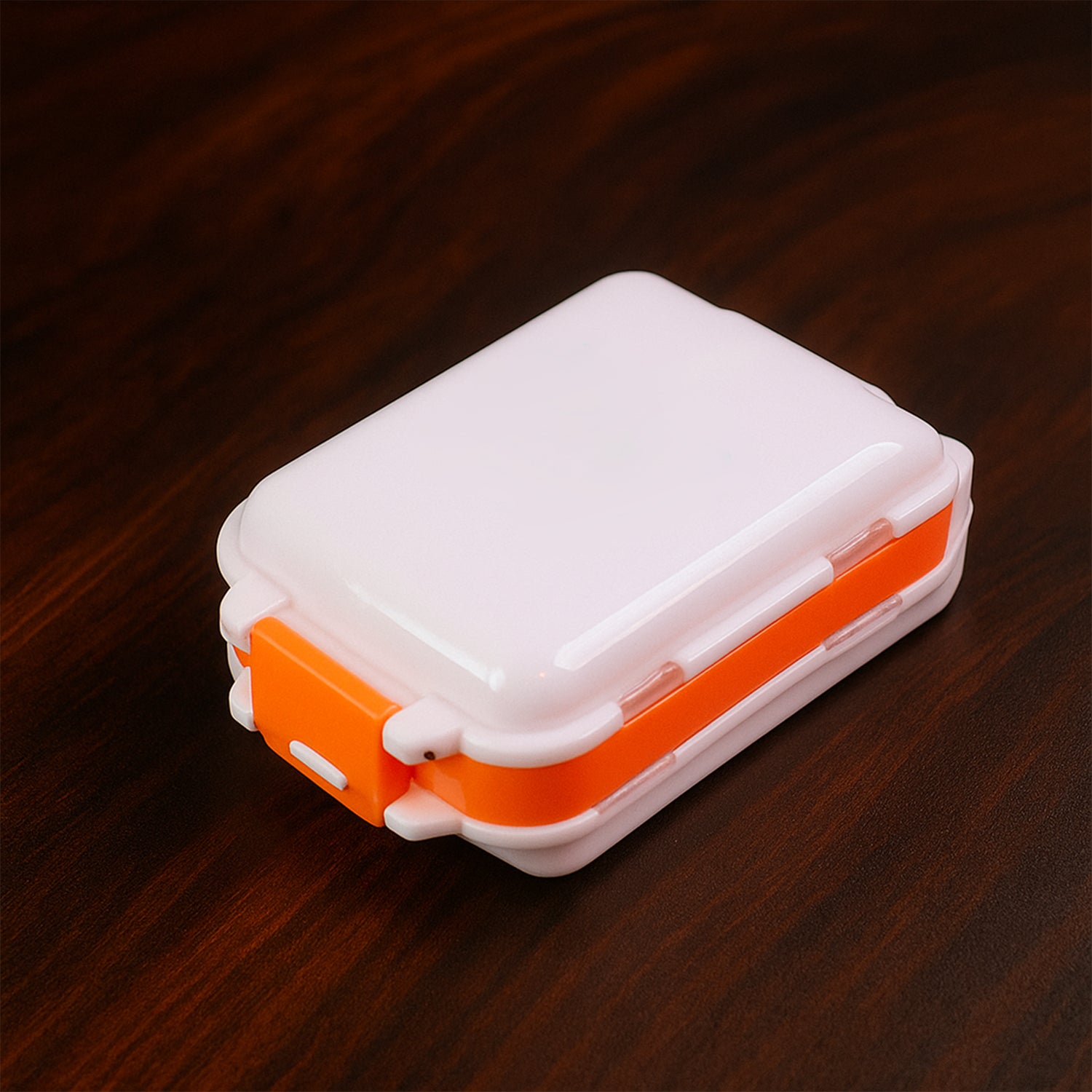 Wukusy portable dual-sided pill organizer box with multiple compartments for daily medication storage, compact and travel-friendly.