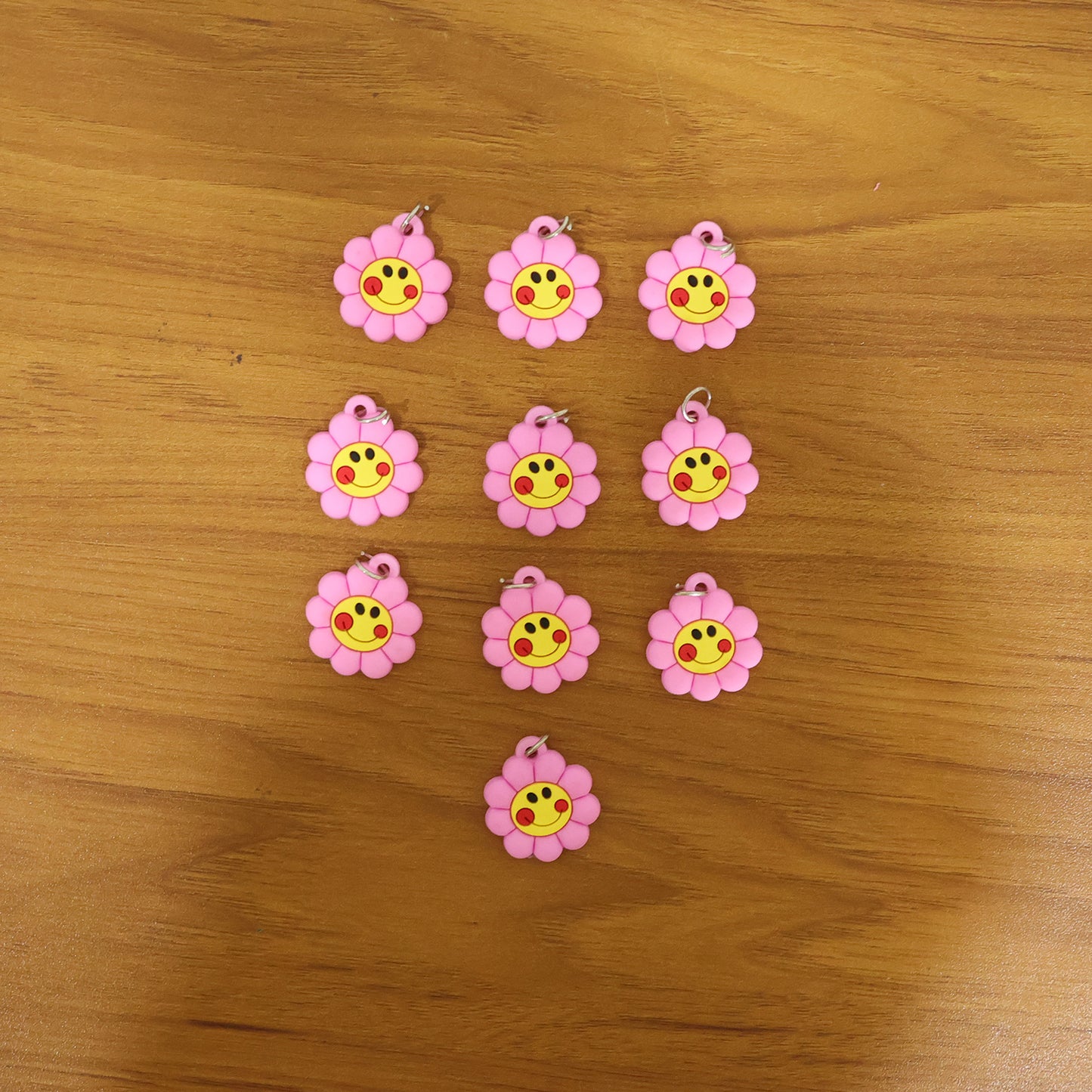 Set of 10 Wukusy smiley flower-shaped bag charm keychains in colorful PVC material.