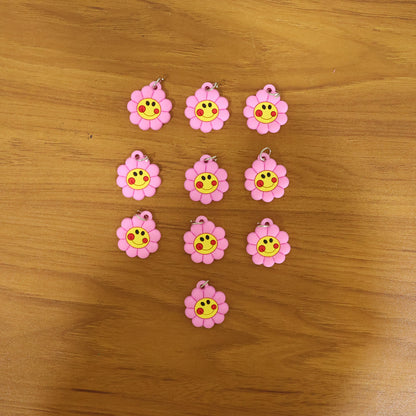 Set of 10 Wukusy smiley flower-shaped bag charm keychains in colorful PVC material.
