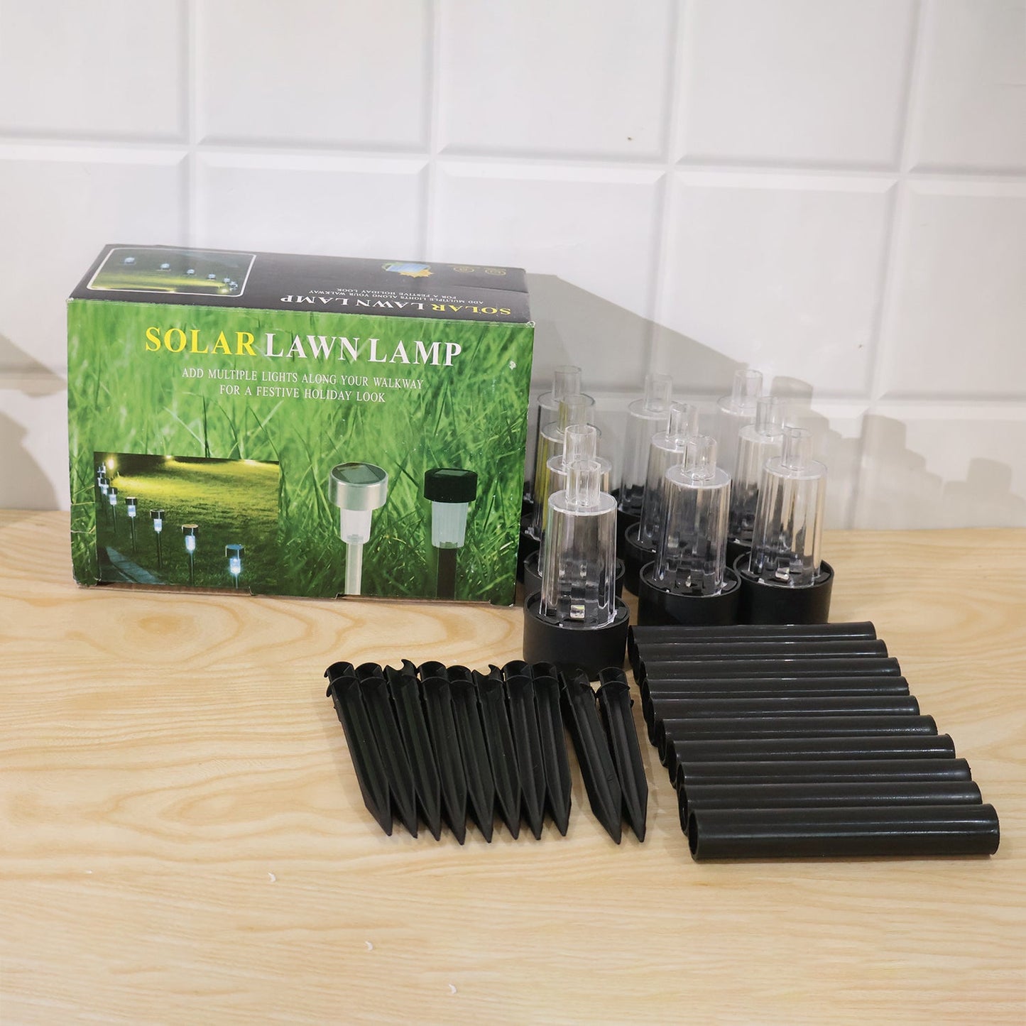 Set of 10 Wukusy solar pathway lights with waterproof outdoor garden stakes and LED bulbs for illuminating walkways.