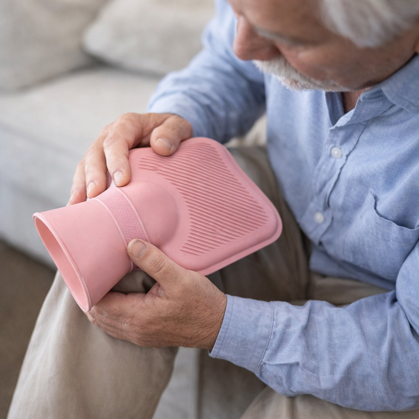 Wukusy reusable hot water bag for pain relief, soft rubber with a fabric cover, designed for warm compress therapy.