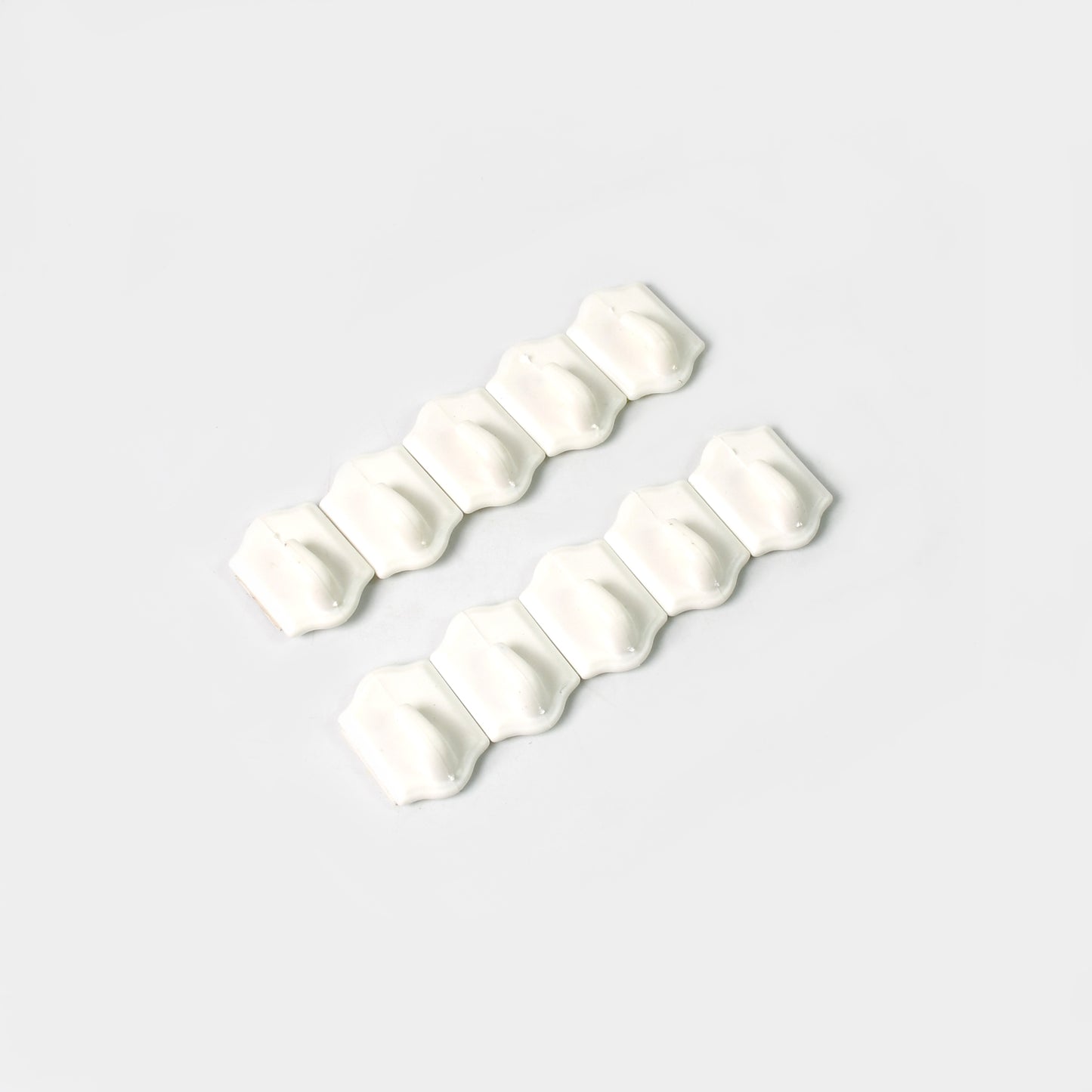 Set of 10 small adhesive hooks by Wukusy for wall hanging, suitable for home and kitchen organization.