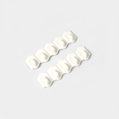 Set of 10 small adhesive hooks by Wukusy for wall hanging, suitable for home and kitchen organization.