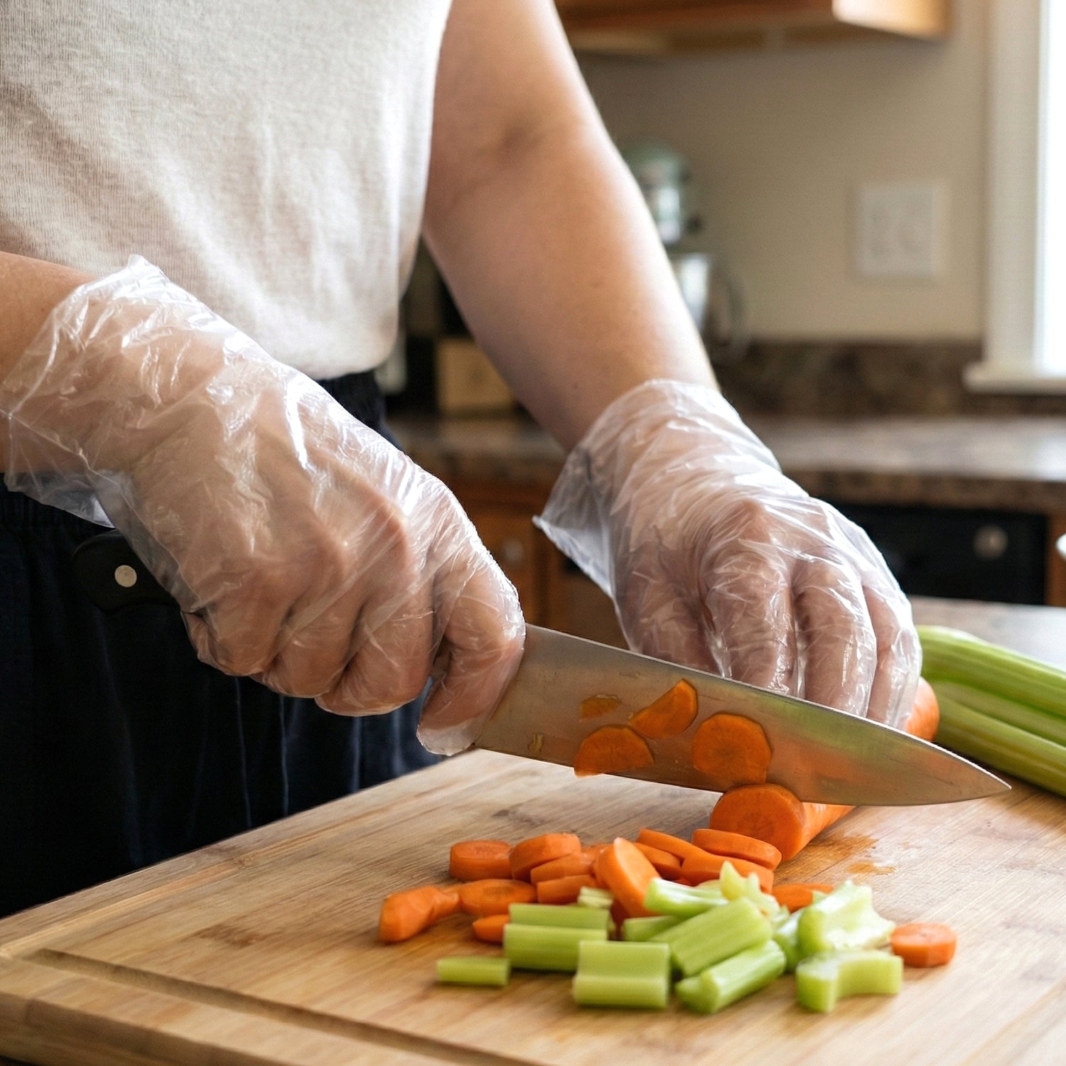 Pair of clear disposable plastic gloves from Wukusy, shown in a 100-piece pack, suitable for hygienic tasks and food handling.