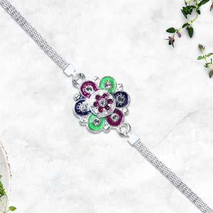 Silver flower motif Rakhi with intricate design, featuring elegant floral details, crafted by Wukusy.