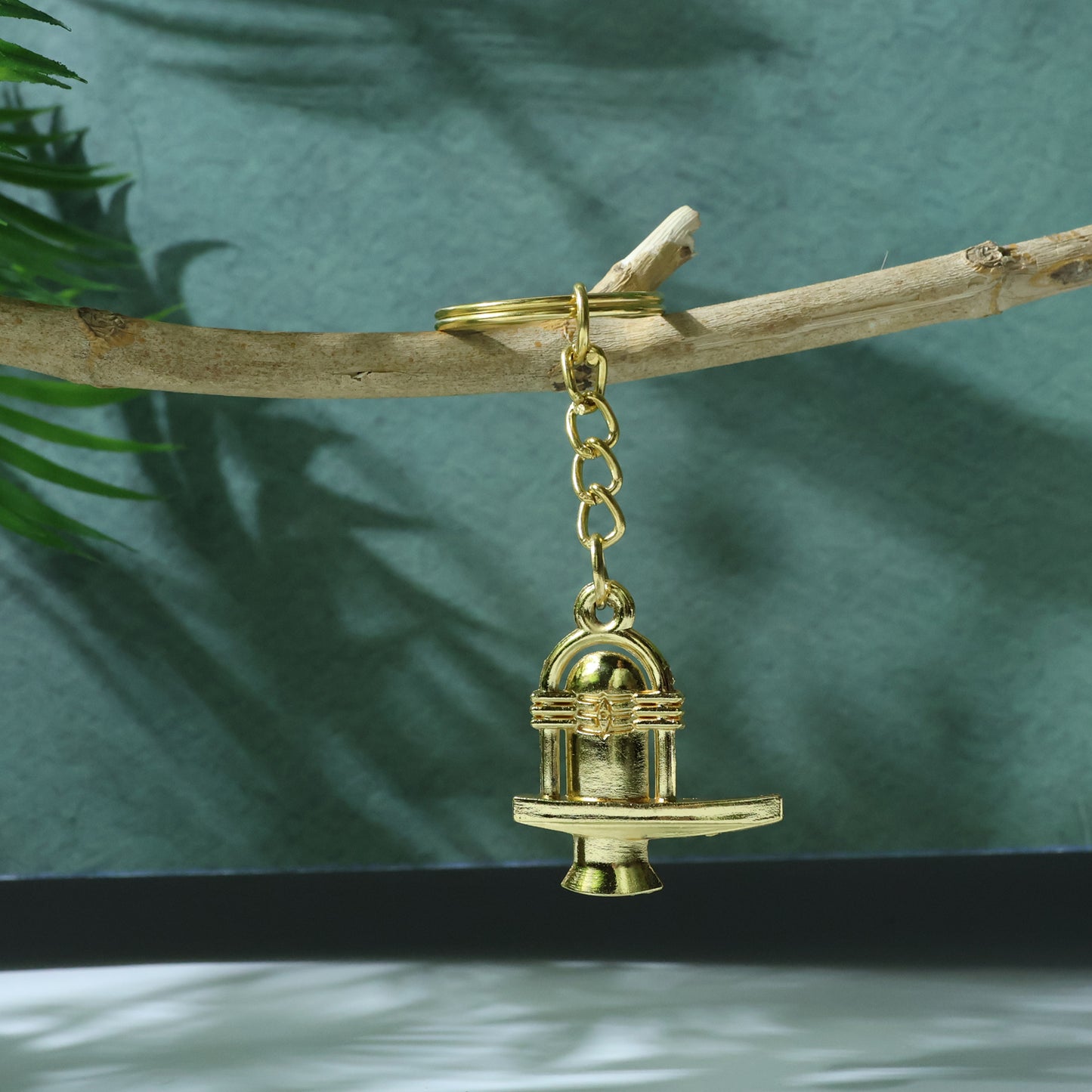 Golden metal Shivling keychain by Wukusy featuring a detailed Shivling design on a small, decorative keychain accessory.