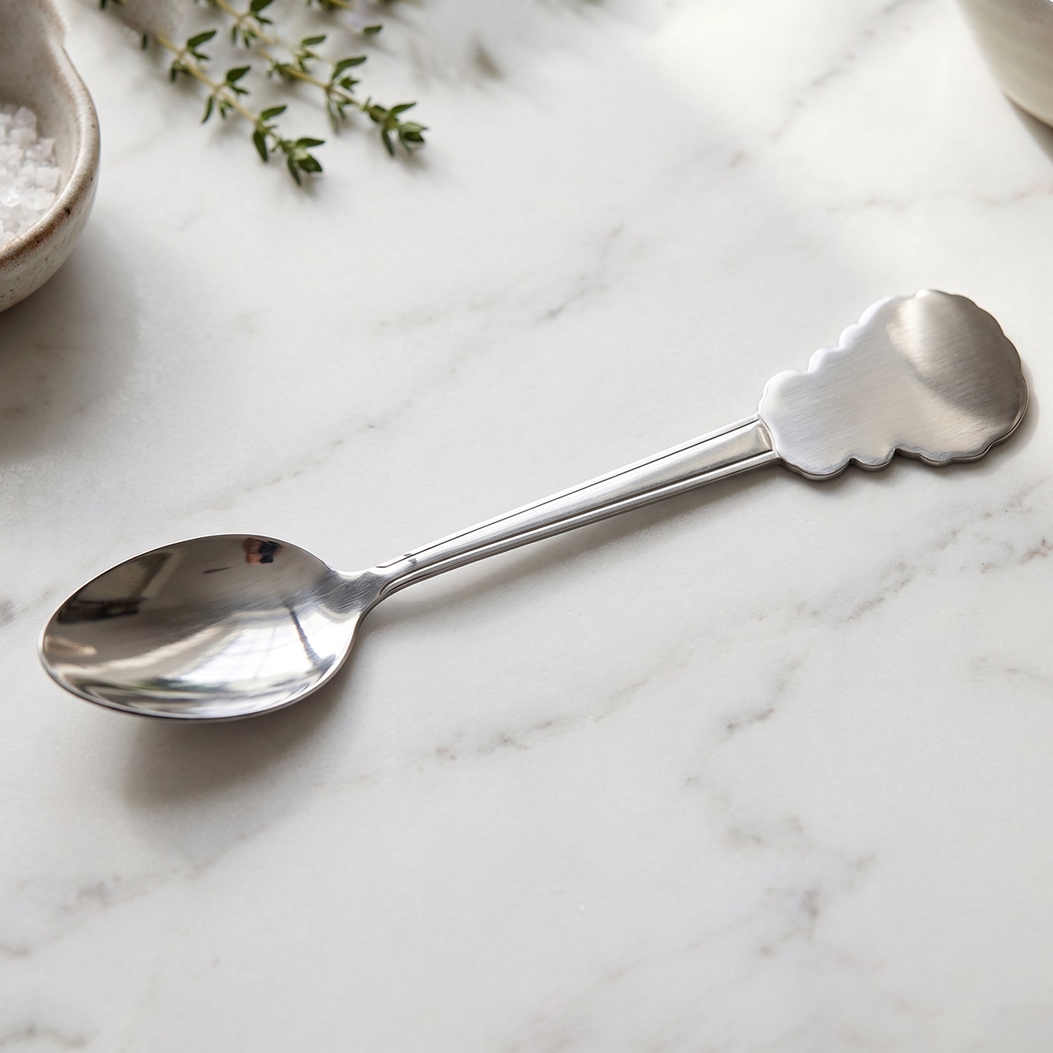 Stainless steel carved handle dinner spoon by Wukusy, ideal for dining and kitchen use, with detailed design on the handle.