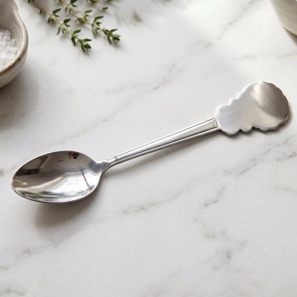 Stainless steel carved handle dinner spoon by Wukusy, ideal for dining and kitchen use, with detailed design on the handle.