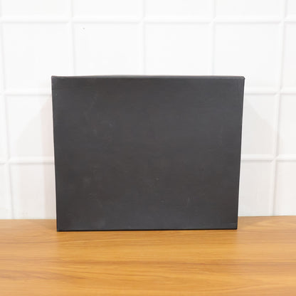 Wukusy Premium 4-in-1 corporate gift set including a sleek pen, notebook, keychain, and business card holder arranged neatly.