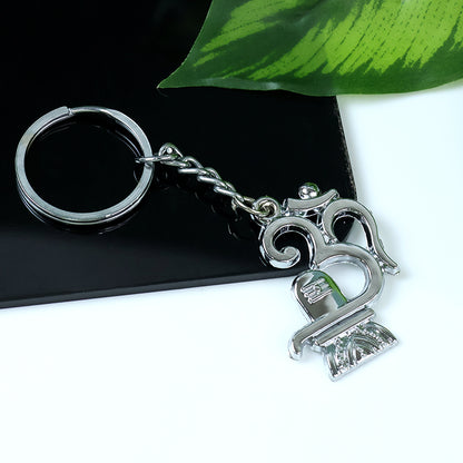 Wukusy metal keychain featuring Om symbol with Shivling design, showcasing intricate craftsmanship and shiny metallic finish.