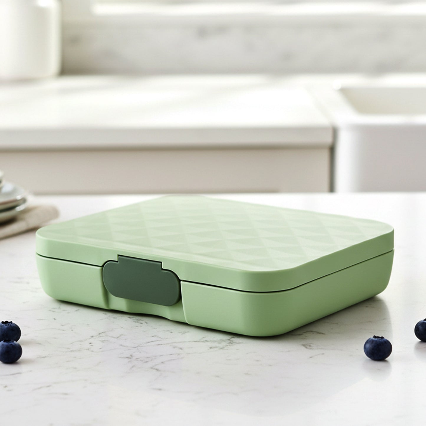 Stainless steel 3-compartment lunch box by Wukusy with secure latches, ideal for packed meals and food storage.