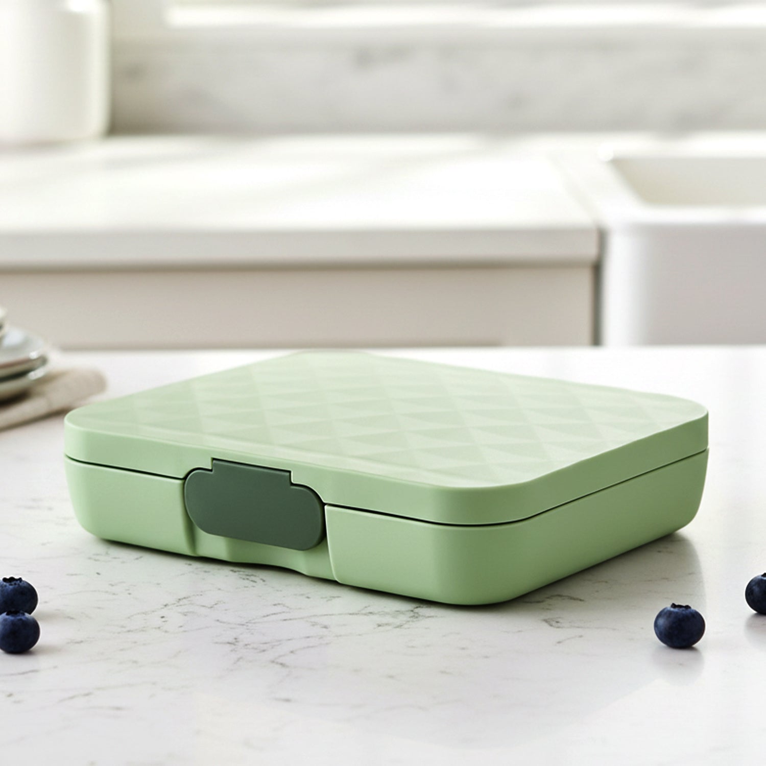 Stainless steel 3-compartment lunch box by Wukusy with secure latches, ideal for packed meals and food storage.