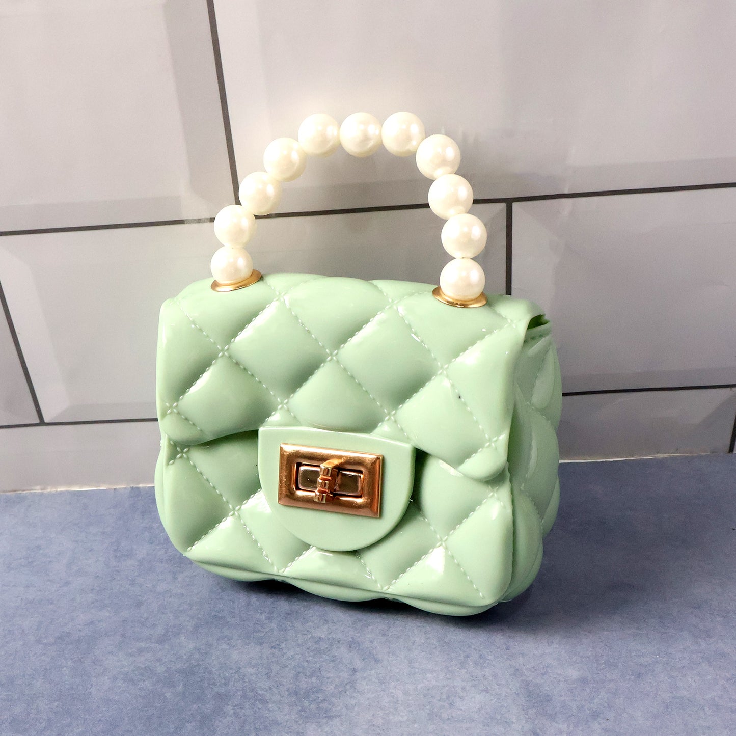Wukusy elegant quilted mini handbag with a fashionable sling design, featuring a compact, stylish handheld purse.