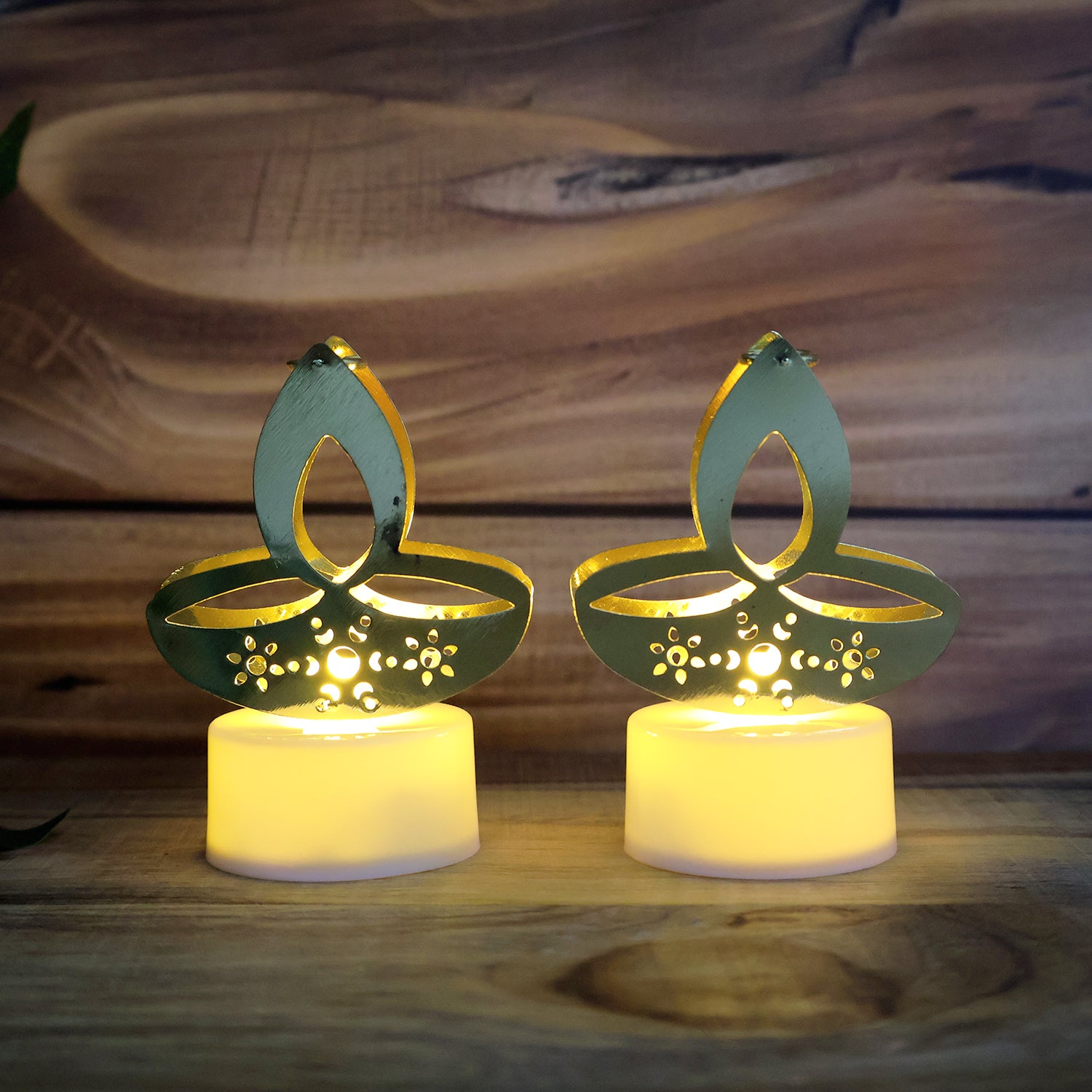 Set of 12 golden diya-shaped LED tealight candles by Wukusy, ideal for home decor and ambient lighting.