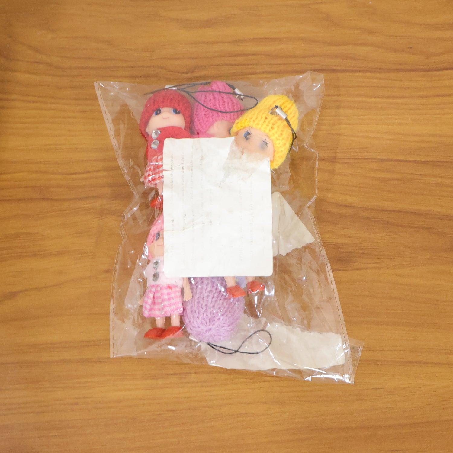 Six colorful mini doll hanging keychains from Wukusy, featuring cute, varied designs on a white background.