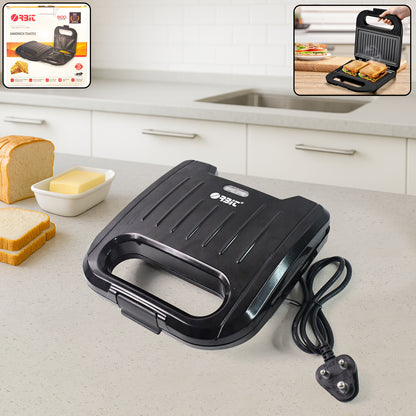 Wukusy Orbit Sandwich Toaster Maker showing two toasted sandwiches with golden-brown crust on a kitchen countertop.