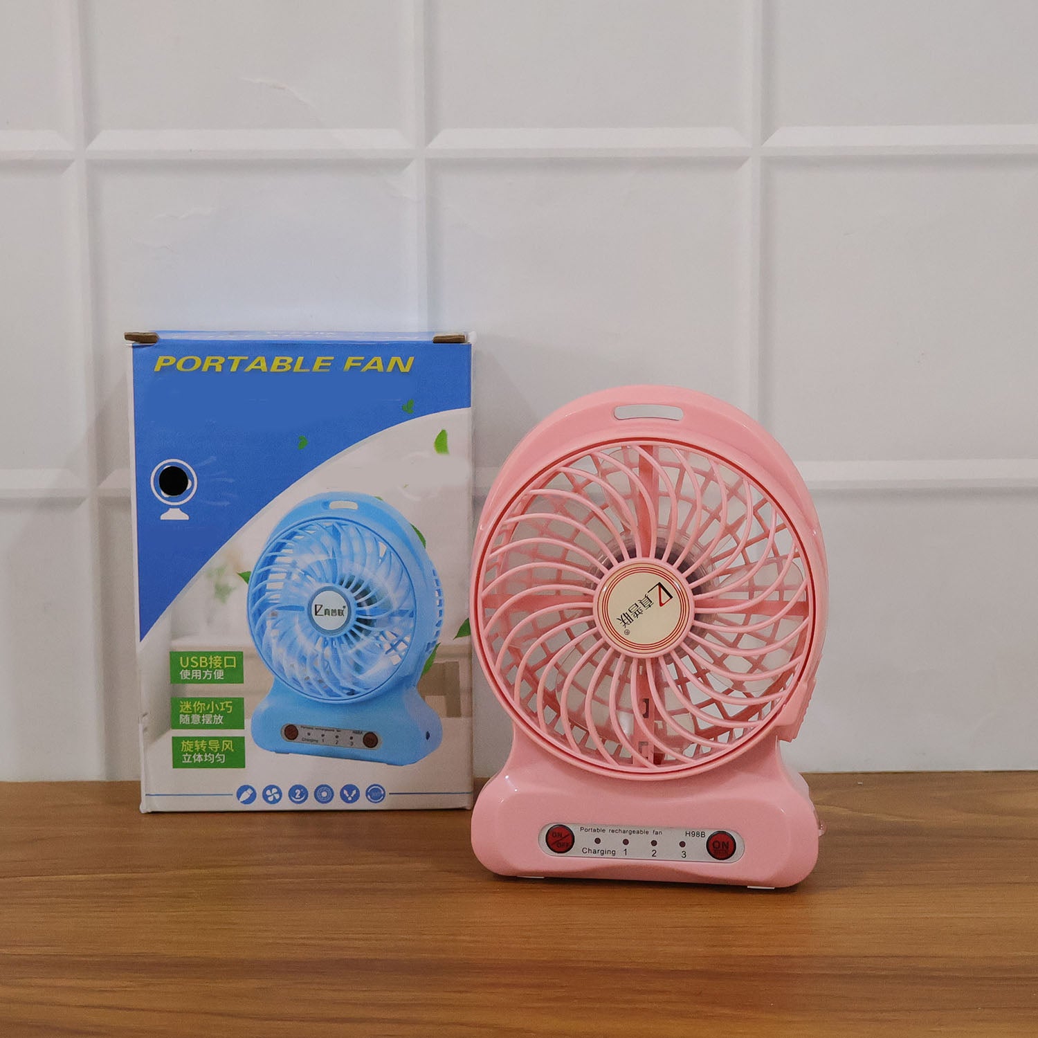 Portable Wukusy USB rechargeable desk fan with adjustable blades and compact design, perfect for personal cooling on a desk.