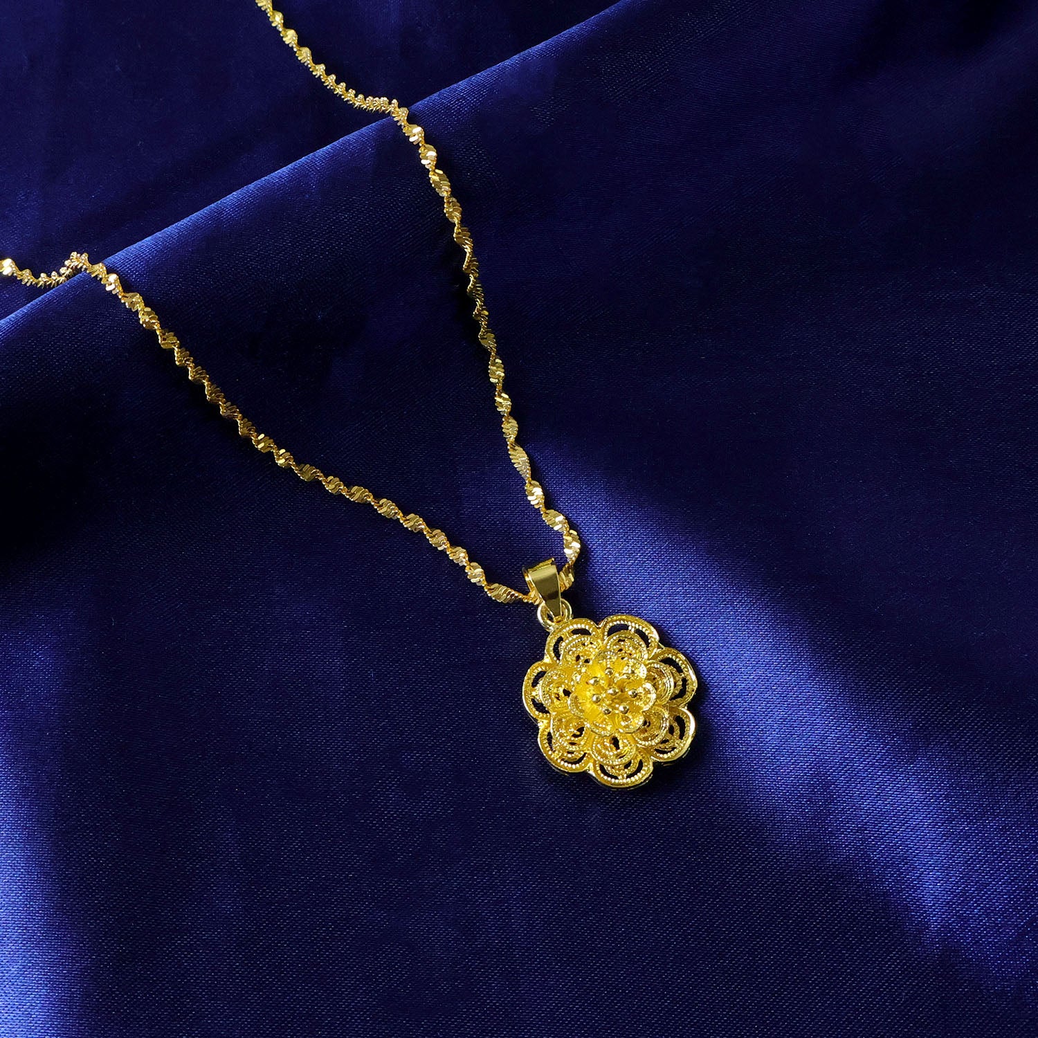 Gold plated pendant necklace with elegant floral design from Wukusy, featuring intricate floral detailing on a delicate chain.