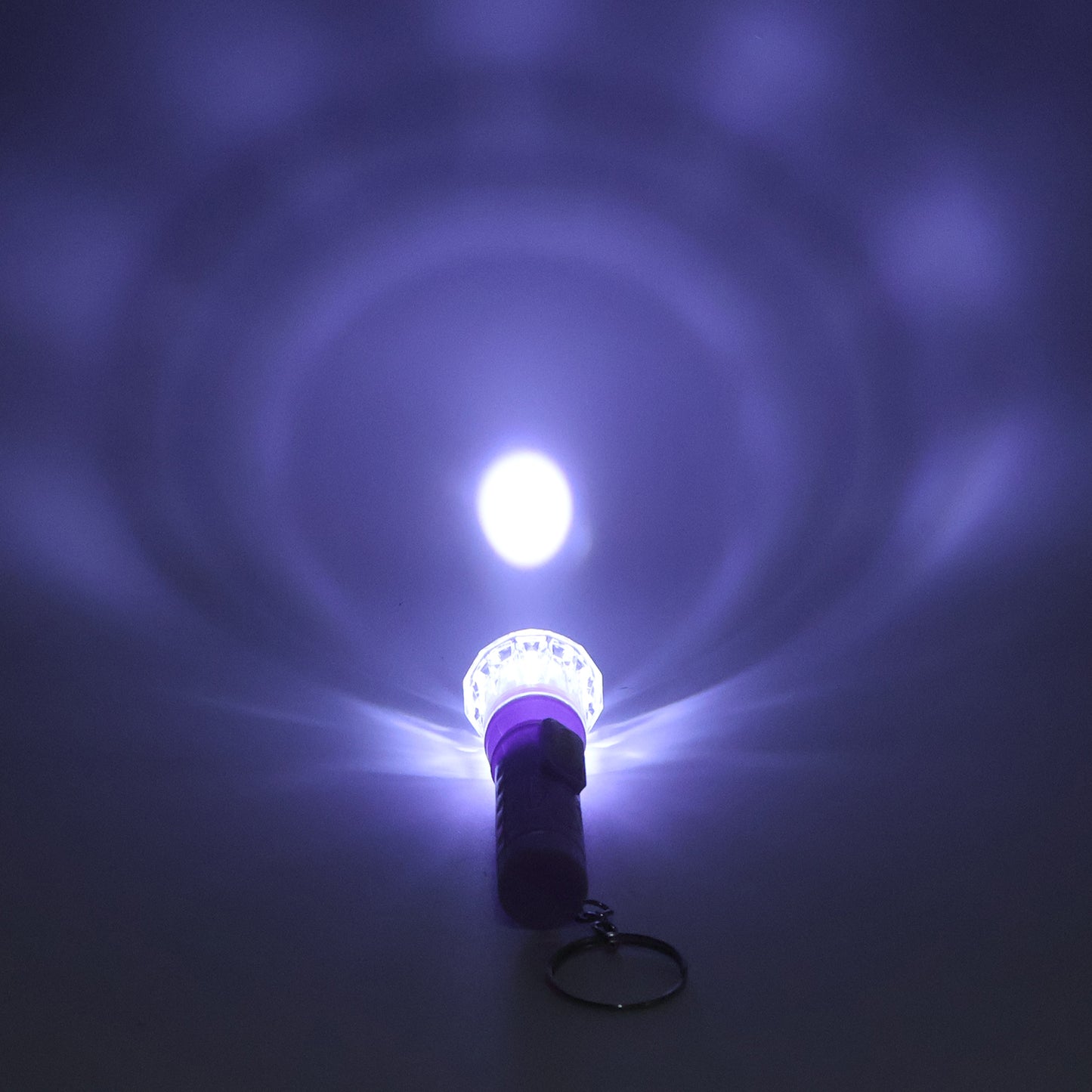 Wukusy Mini LED flashlight keychain torch in mixed colors, compact toy with bright LED light and colorful design.