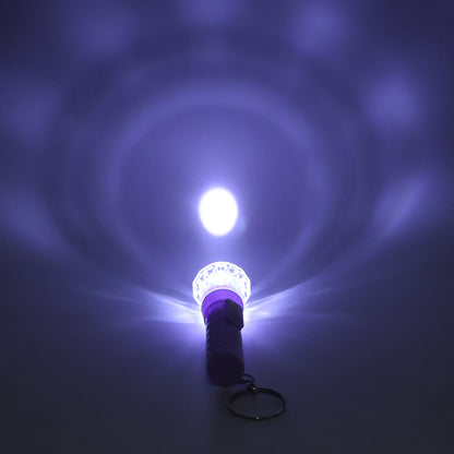 Wukusy Mini LED flashlight keychain torch in mixed colors, compact toy with bright LED light and colorful design.