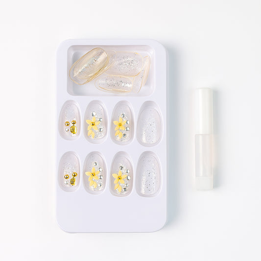 Set of Wukusy premium glitter 3D floral press-on artificial nail tips with nail glue on a white background
