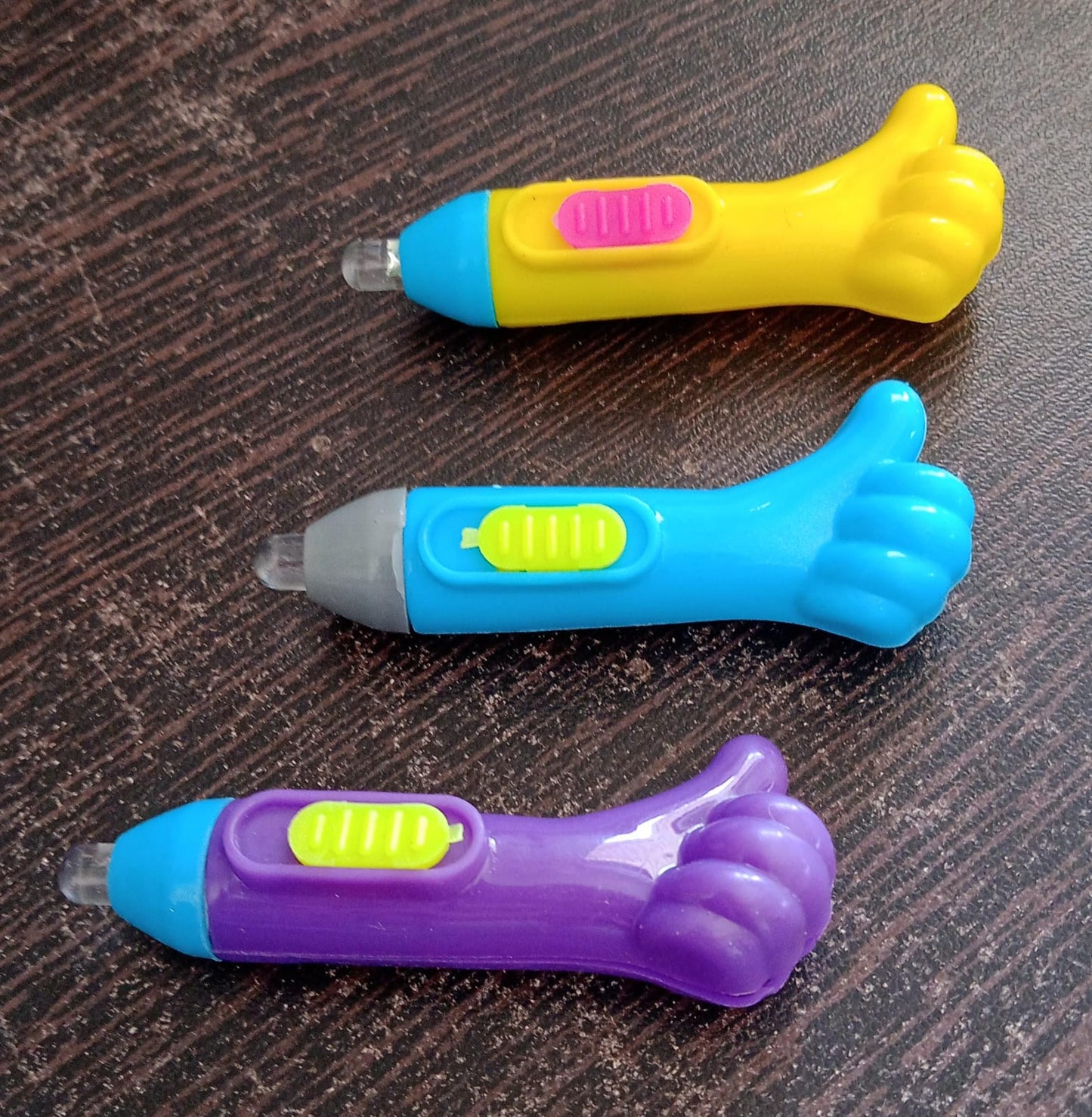 Wukusy thumb-shaped LED light keychain toy with bright illumination, fun lightning design, perfect for portable lighting and playful use.