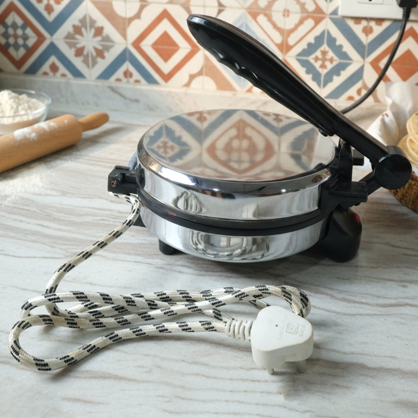 Wukusy electric roti maker with stainless steel heating plate for quick, even bread cooking in a compact kitchen appliance
