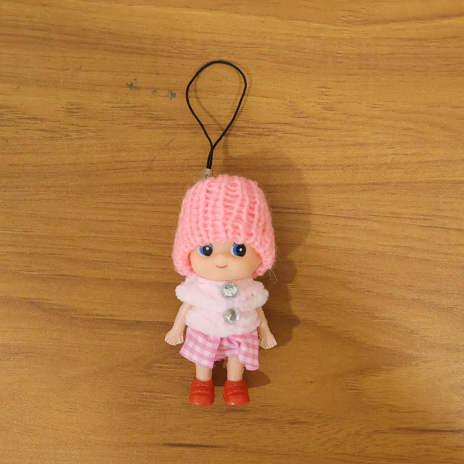 Cute mini doll keychain by Wukusy featuring a soft knitted cap girl charm on a colorful keyring.