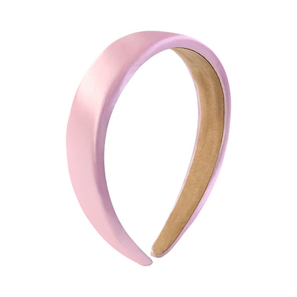 Elegant padded satin finish hairband by Wukusy, showcasing its smooth satin surface and comfortable padded design for stylish hair accessories.