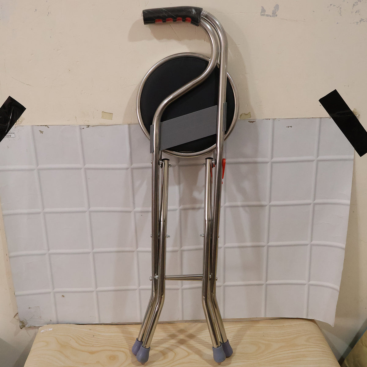 Wukusy folding walking stick with seat and backrest, four-leg cane stool chair, compact and portable for mobility assistance.