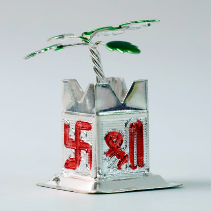 Miniature Tulsi plant idol with mandir and kalash base, ideal for home decor by Wukusy, shown on a wooden surface.