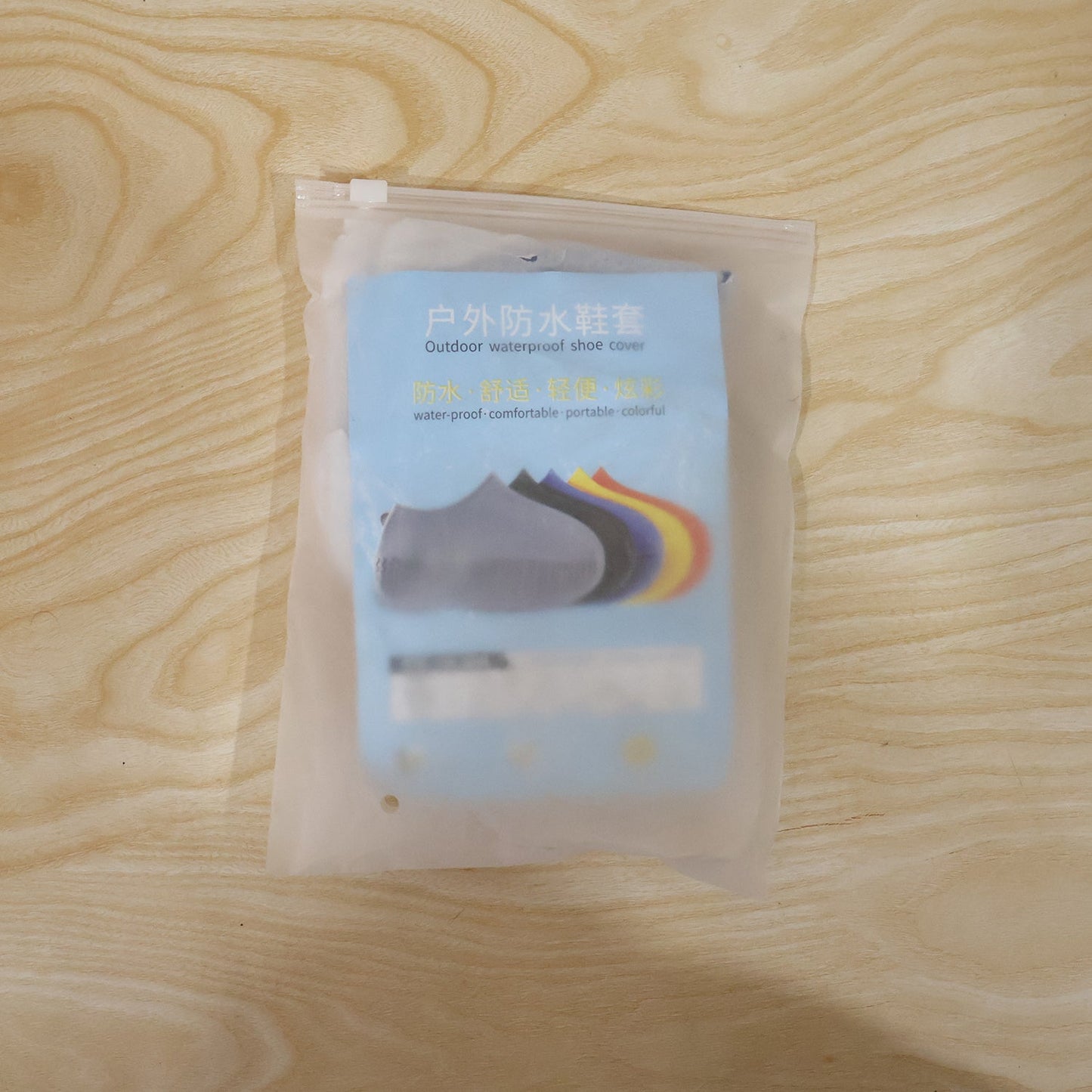 Pair of blue Wukusy reusable waterproof silicone rain shoe covers for small shoes, non-slip design, shown on a clean surface.