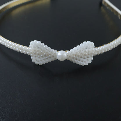 Elegant pearl beaded slim metal hair band by Wukusy, featuring delicate pearl accents on a sleek metal band for a stylish look.