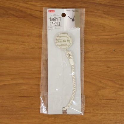 Elegant magnetic curtain tieback by Wukusy holding a beige curtain, showcasing its sleek design and secure magnetic closure.