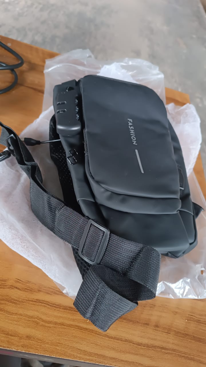 Wukusy trendy anti-theft crossbody sling bag with USB charging port, travel-style with sleek black design and adjustable strap.