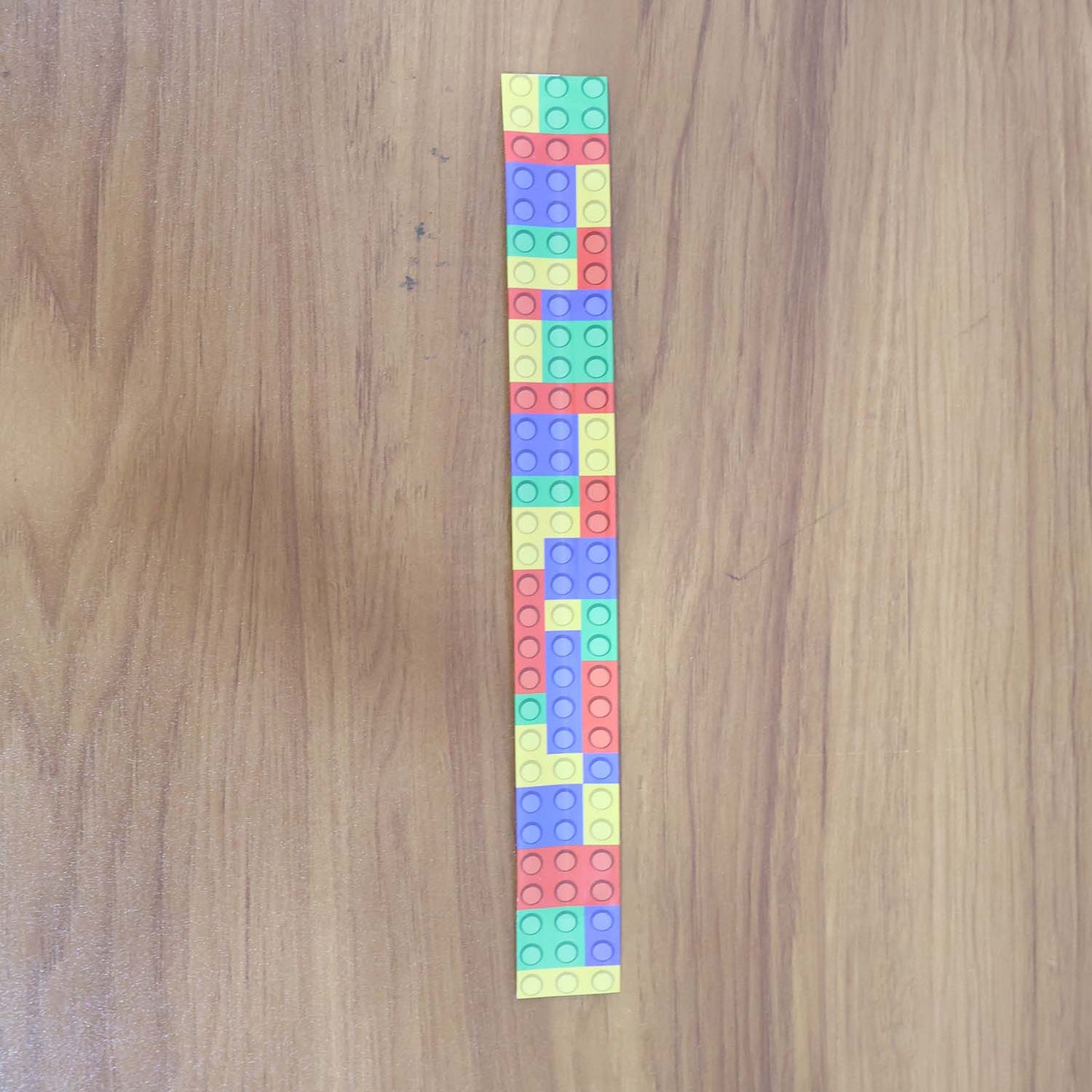 Colorful Snap Slap Bracelet toy by Wukusy, featuring vibrant, flexible plastic design perfect for kids to wear and play with.