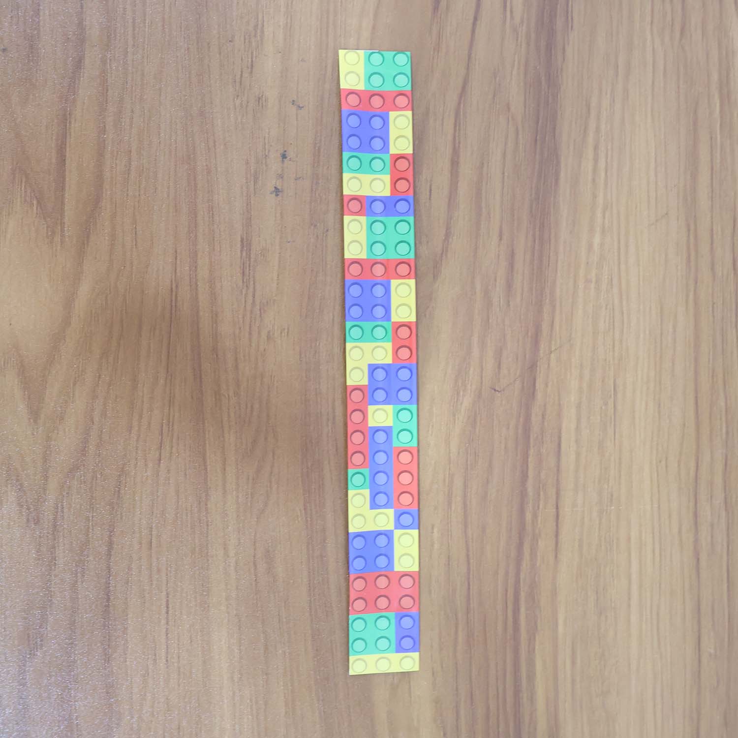 Colorful Snap Slap Bracelet toy by Wukusy, featuring vibrant, flexible plastic design perfect for kids to wear and play with.