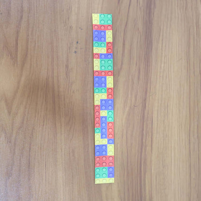 Colorful Snap Slap Bracelet toy by Wukusy, featuring vibrant, flexible plastic design perfect for kids to wear and play with.