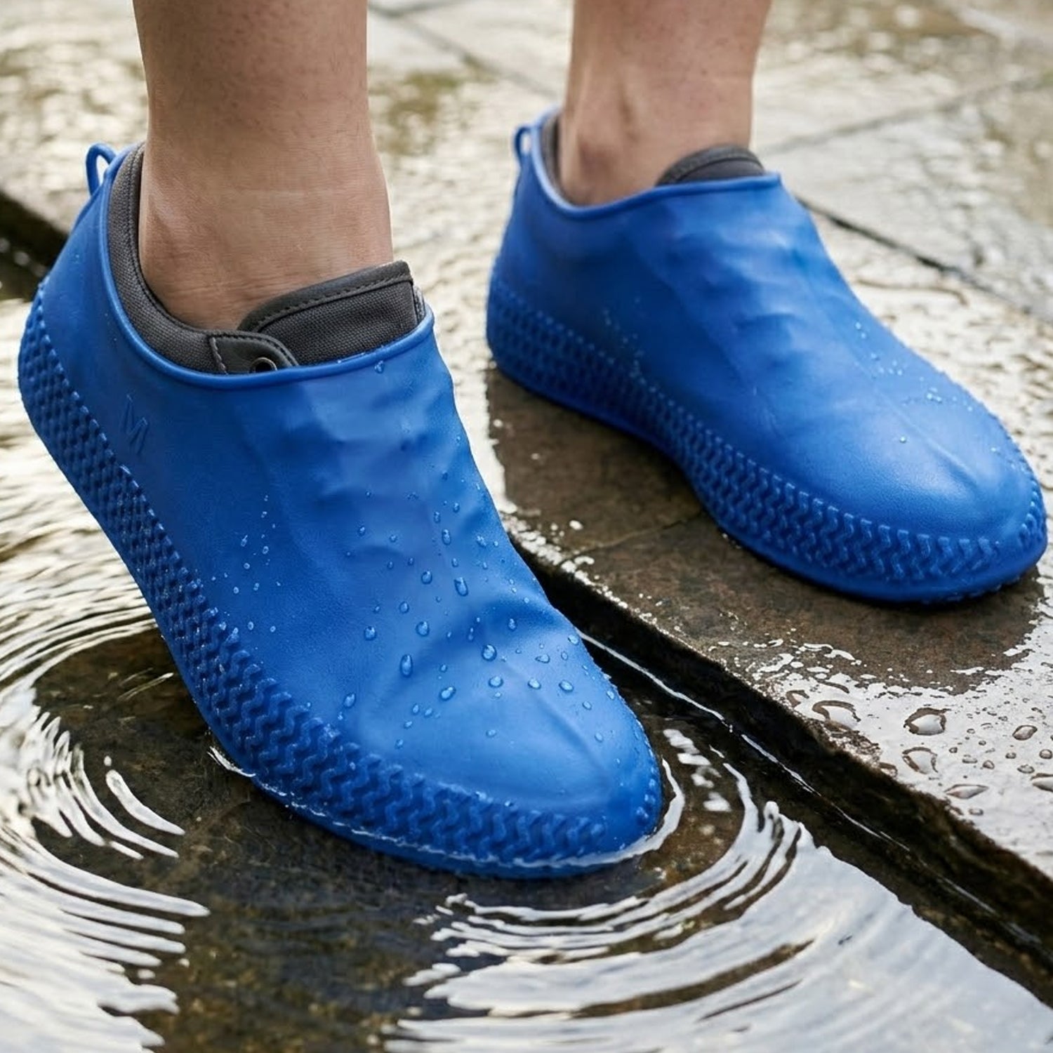 Pair of blue Wukusy waterproof silicone shoe covers in medium size, designed to protect shoes from water and dirt.