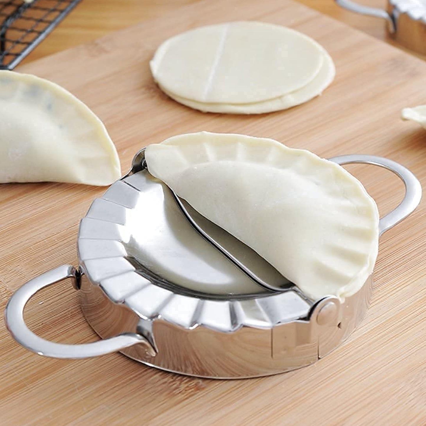 Stainless steel Wukusy dumpling mold for making evenly shaped dumplings, durable and rust-resistant, ideal for home use.