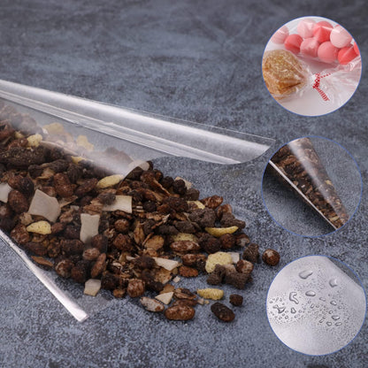 Set of 100 small disposable piping bags by Wukusy, shown filled with icing and ready for decorating baked goods.