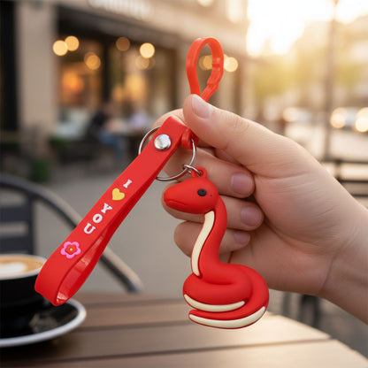 Cute cartoon snake keychain by Wukusy, featuring a colorful, playful snake design on a metal keyring.
