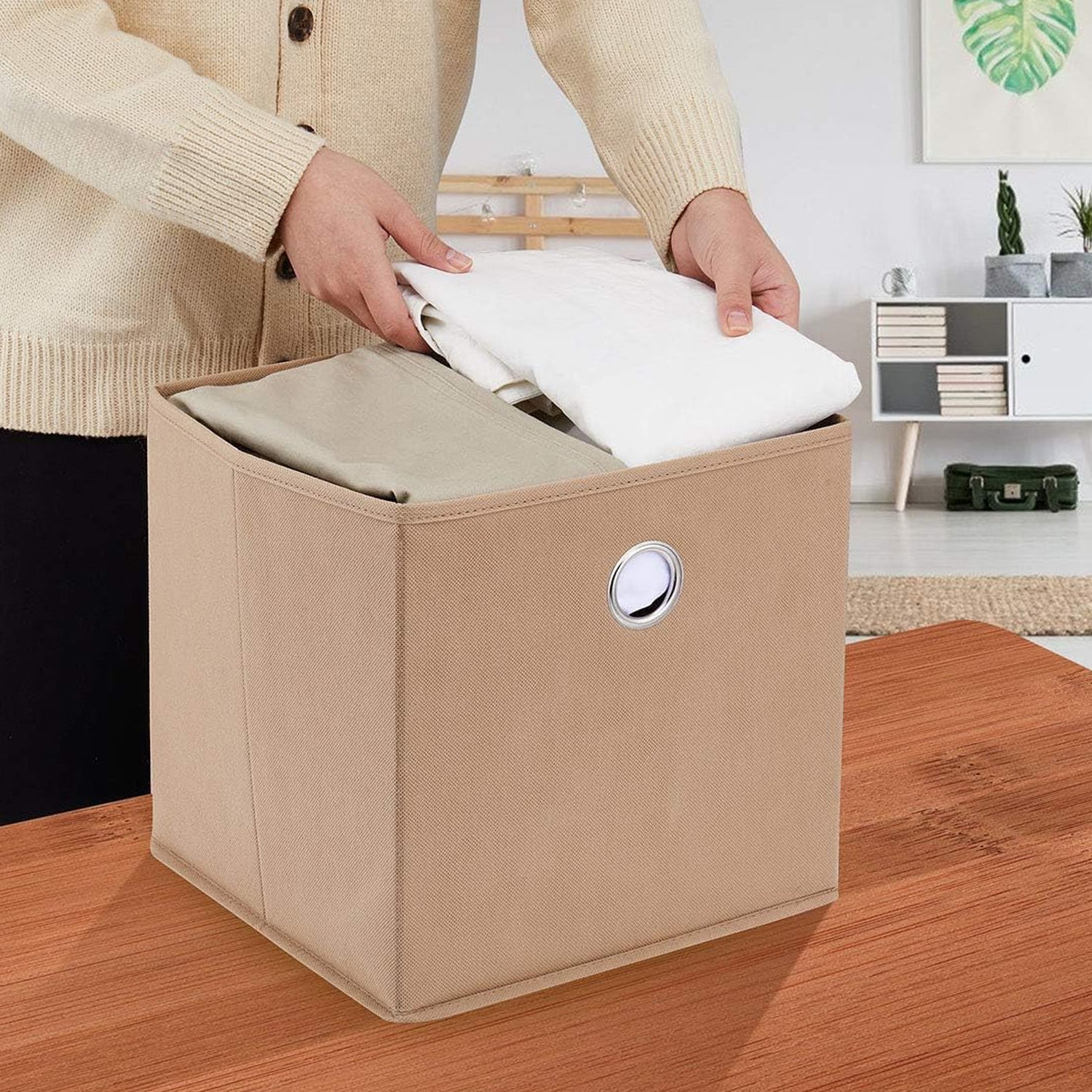 Foldable square storage box by Wukusy, 20x20 cm, made of durable material, shown folded open to reveal interior storage space.