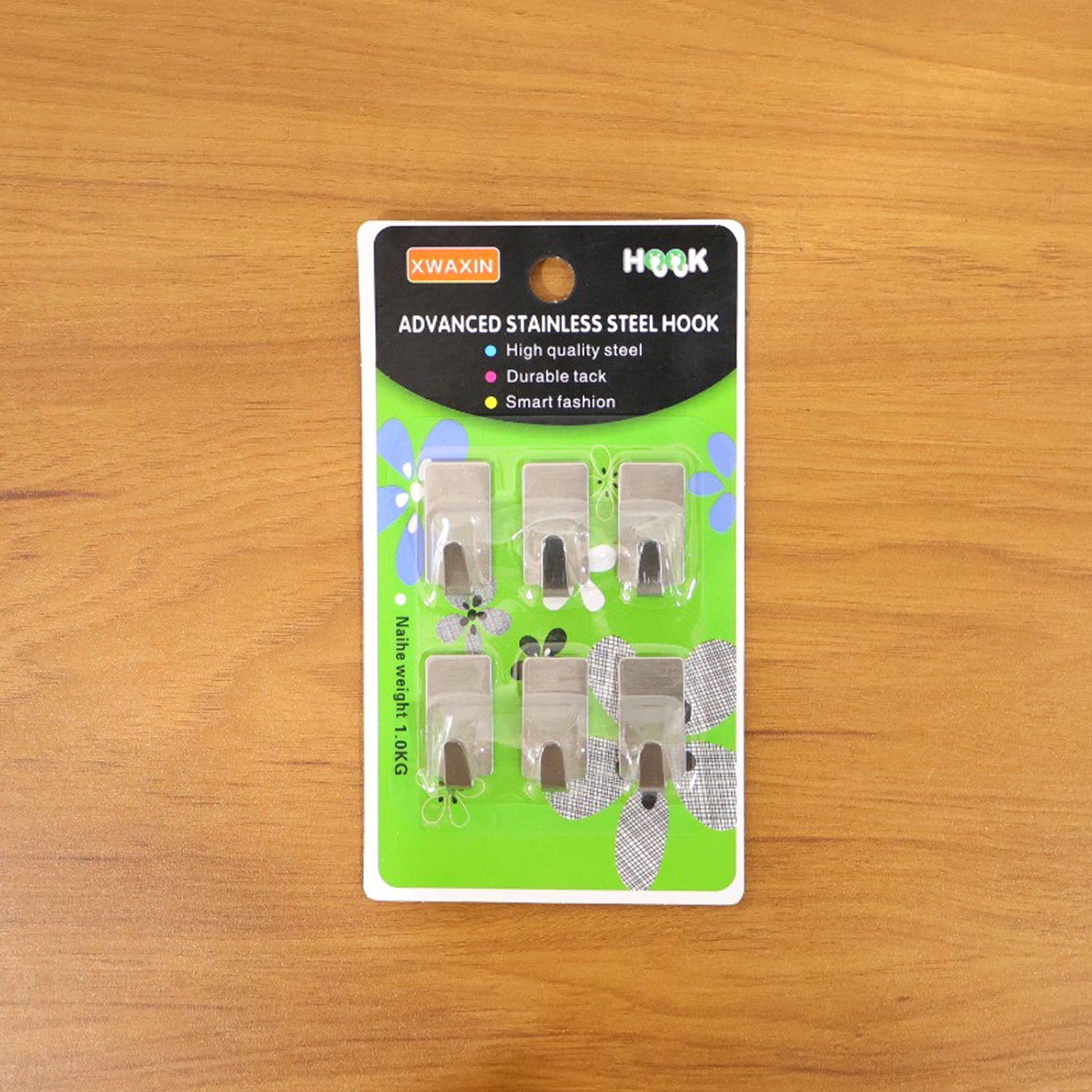 Set of six Wukusy self-adhesive wall hooks attached to a wall, showing versatile hanging options for organization.