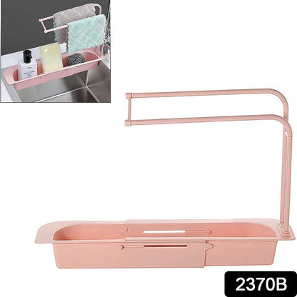 Wukusy over-sink expandable sink caddy with dual towel bar and drip tray, holding sponges and washing accessories.
