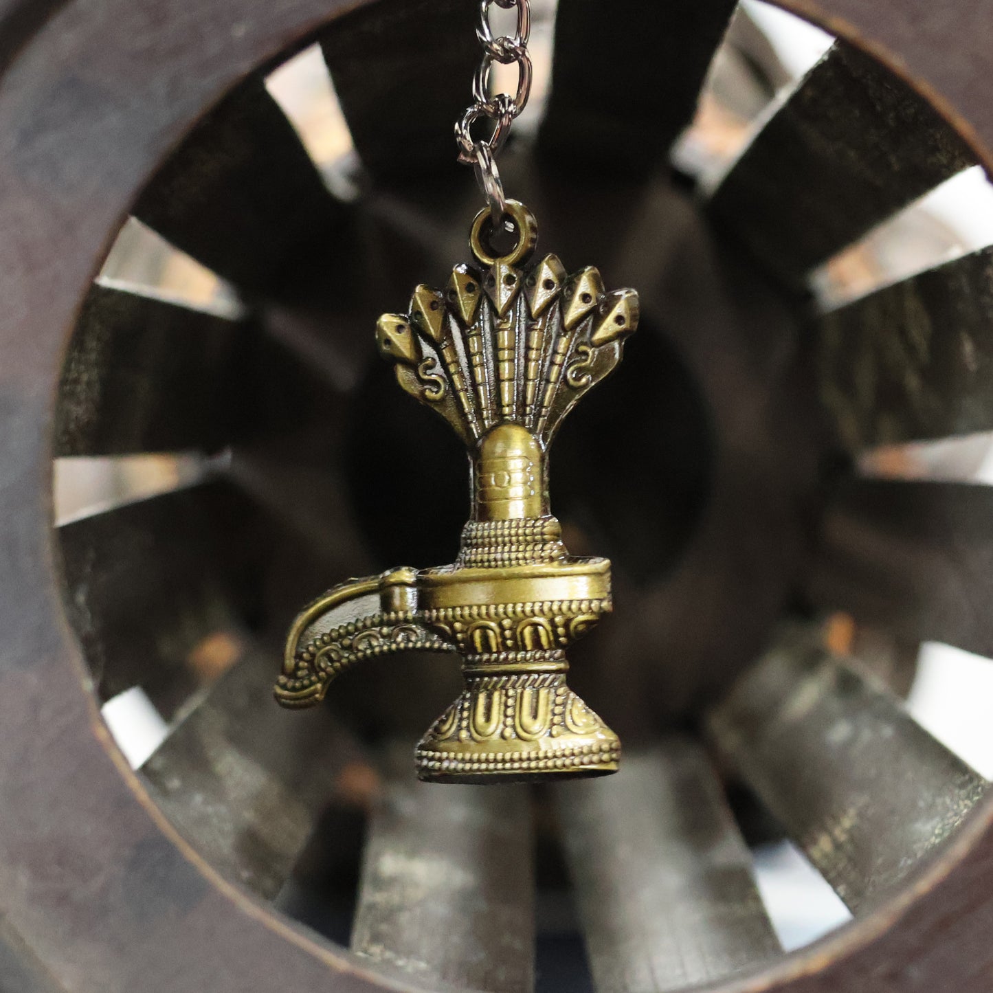 Antique Lord Shiva Shivaling metal keychain from Wukusy, featuring detailed Shivaling design on a small, decorative keychain.