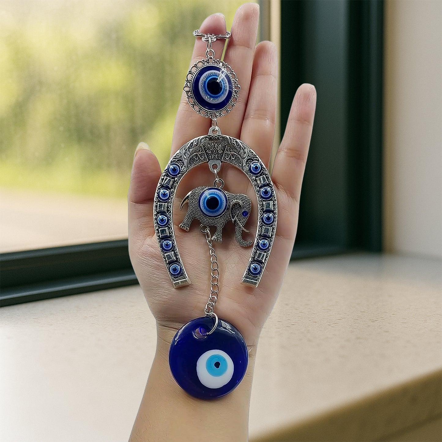 Decorative evil eye wind chime with elephant and horseshoe motifs, hanging ornament by Wukusy, featuring colorful beads and charms